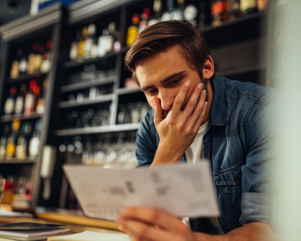 Business owner checking tax bill for his small business.